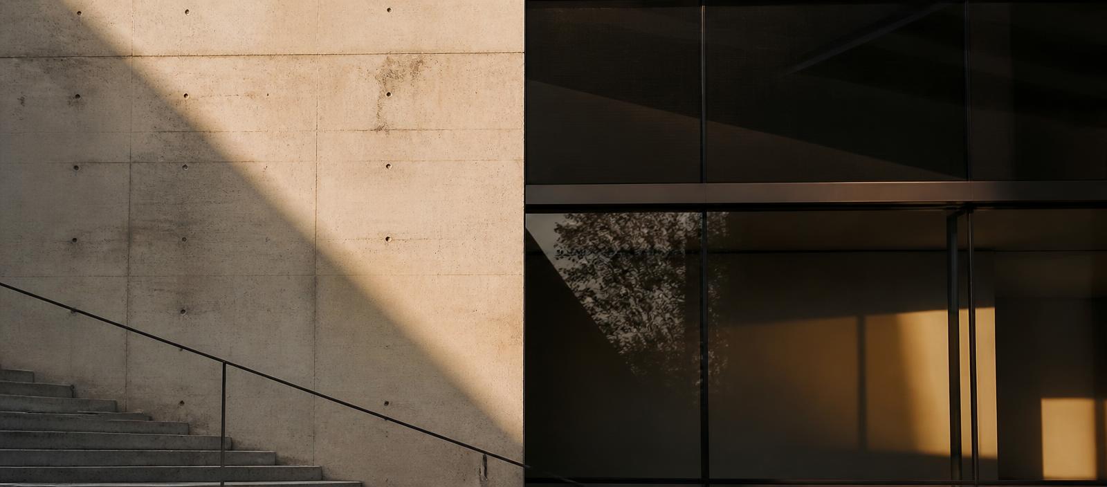 Concrete and glass architectural detail with a strong diagonal shadow